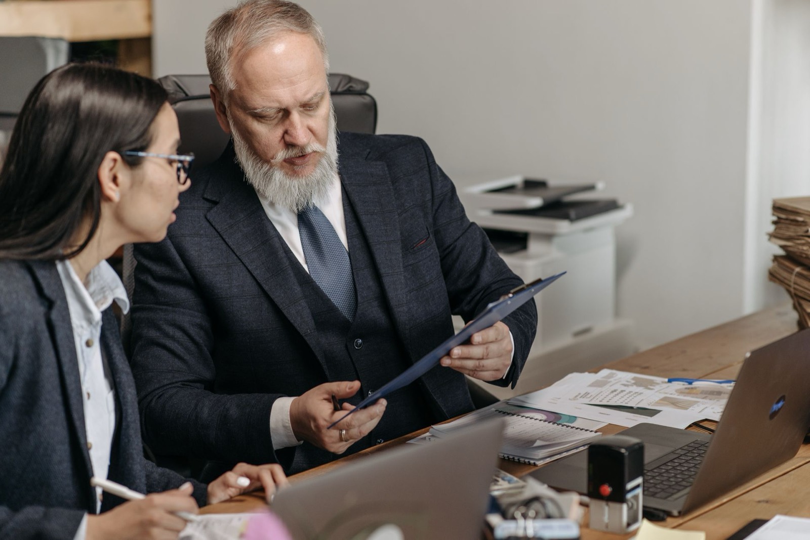 Attorneys meeting across a desk for mentorship